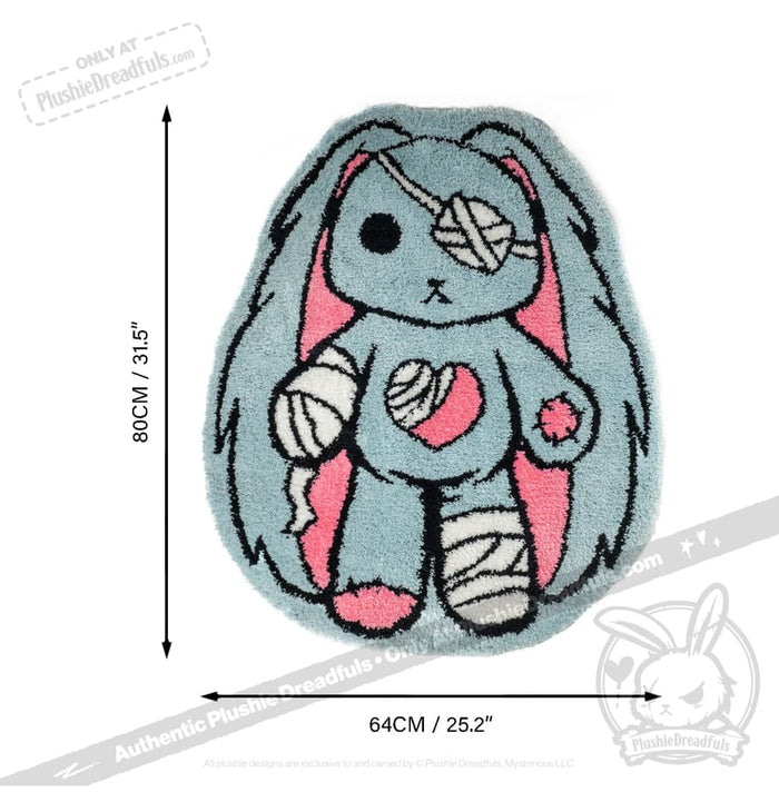 Ouchie Rabbit Rug: A blue and pink bunny rug with bandages, measuring 80cm x 64cm from Plushie Dreadfuls.